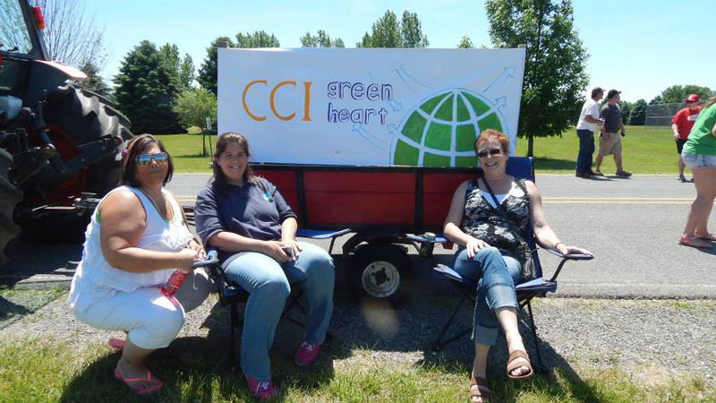 local coordinator in front of cci greenheart sign