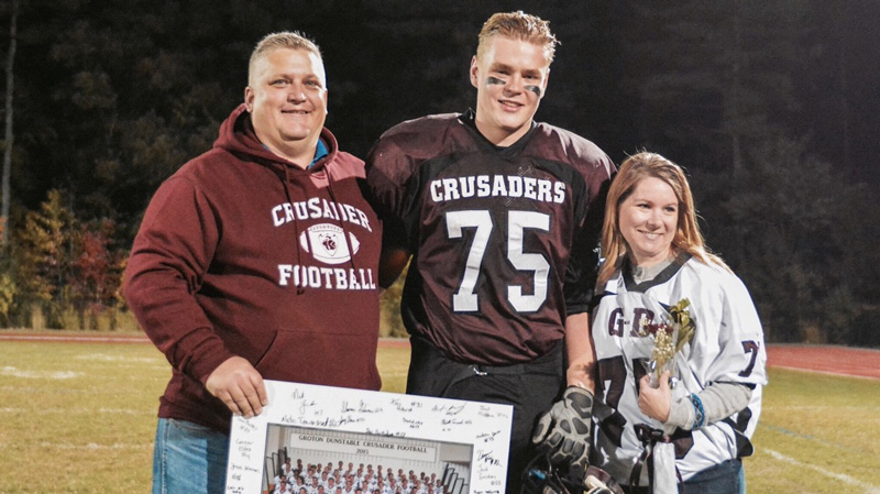 F-1 high school student in football uniform with host family